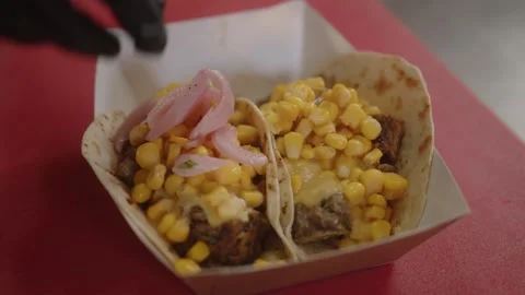 Chef making beef tacos with corn and marinated onions, close-up Video stock 246237580
