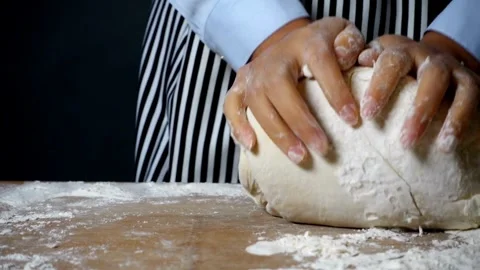 Chef Making bread Baker kneading dough flour on wooden table enjoying hobby.. Stock Footage 272566193