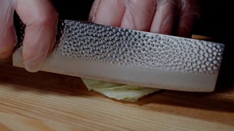 Chef making burger. Close up of man chopping fresh lettuce for hamburger or Stock Footage 97573950
