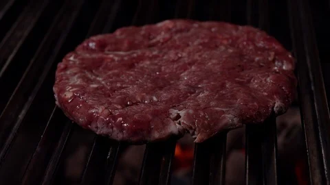 Chef making burger. Cooking hamburger. Beef or pork cutlet grilling on grid. 4K Stock Footage 97575013