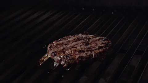 Chef making burger. Cooking hamburger. Beef or pork cutlet grilling on grid. 4K Stock Footage 97575326