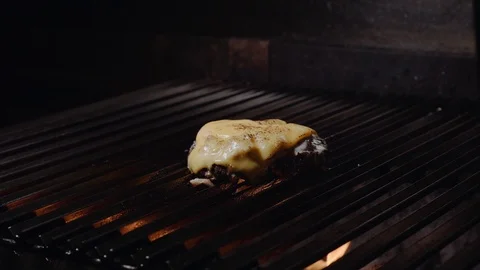 Chef making burger. Cooking hamburger. Beef or pork cutlet grilling on grid. 4K Stock Footage 97575649
