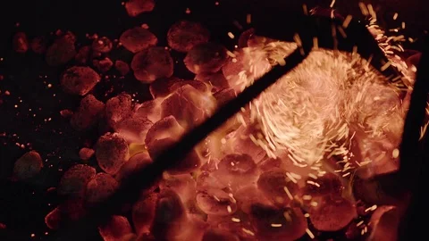 Chef making burger. Iron stick mixes burning coal. Stock Footage 97573357