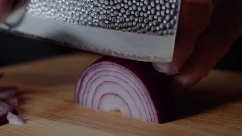 Chef making burger. Man slices the onion. Quick cutting of vegetables. Half Stock Footage 97573738