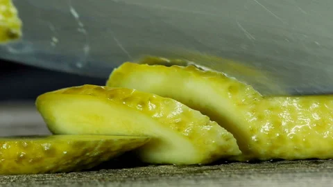 Chef making burger. Mans hands sliced pickled cucumbers with knife close-up Video stock 106131320