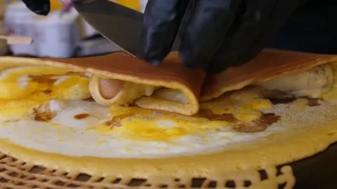 Chef Making Crispy Savory Crepe with Egg Close-Up Stock Footage 345692605