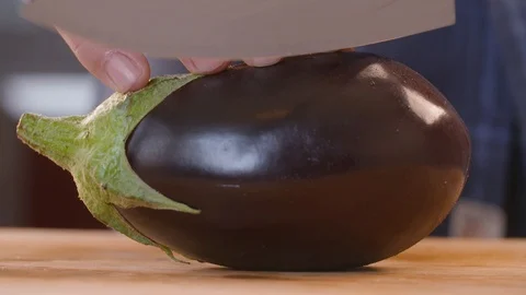 Chef making cuts in the eggplant with a sharp knife Stock Footage 86171034