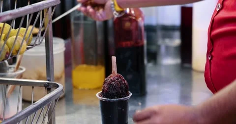 A chef making famous Indian crushed ice dolly popsicle called Ice Gola. Stock Footage 169833401