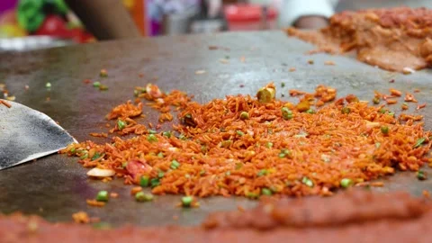 A chef making Indian Rice dish Tawa Pulao / Biryani / Fried Rice Stock Footage 166909256