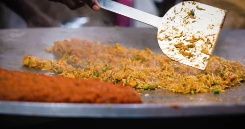 A chef making Indian Rice dish Tawa Pulao / Biryani / Fried Rice closeup Stock Footage 169833709