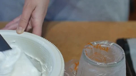 Chef making muffins. Decorating cupcakes with butter cream. Closeupf of hand Stock Footage 76628687