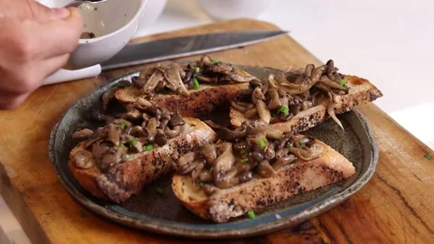 Chef making mushroom bruschetta on table Stock Footage 153771646