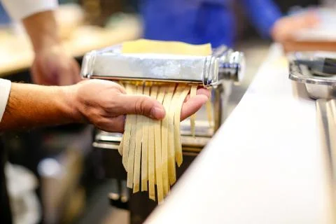 Chef making pasta with a machine, home made  fresh pasta Stock Photos