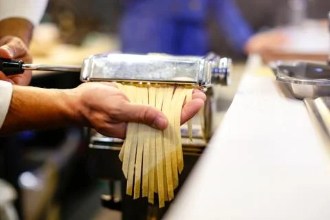 Chef making pasta with a machine, home made  fresh pasta Stock Photos
