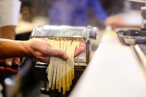 Chef making pasta with a machine, home made  fresh pasta Stock Photos