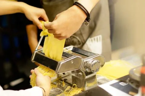 Chef making pasta with a machine, home made  fresh pasta Stock Photos