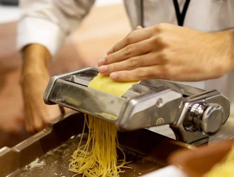 Chef making pasta with a machine, home made  fresh pasta Stock Photos
