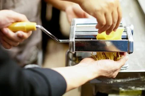 Chef making pasta with a machine, home made  fresh pasta Stock Photos