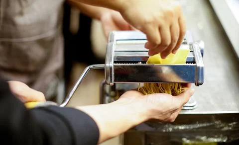 Chef making pasta with a machine, home made  fresh pasta Stock Photos