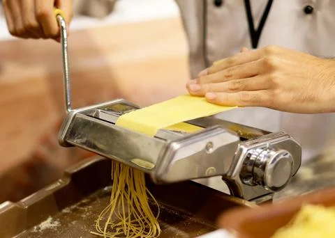 Chef making pasta with a machine, home made fresh pasta Stock Photos