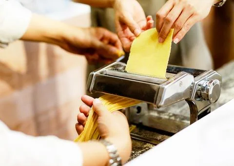 Chef making pasta with a machine, home made fresh pasta Stock Photos
