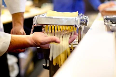 Chef making pasta with a machine, home made fresh pasta Stock Photos