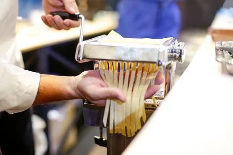 Chef making pasta with a machine, home made fresh pasta Stock Photos