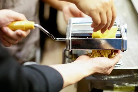 Chef making pasta with a machine, home made fresh pasta Stock Photos