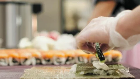 A chef is making Philadelphia rolls Stock Footage 79936863