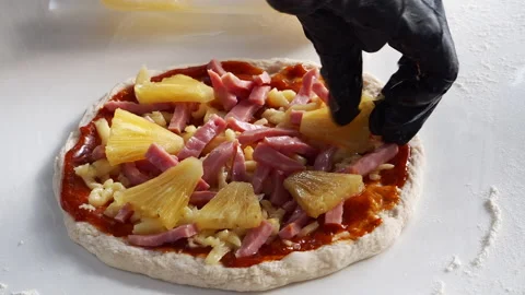 Chef is making pizza with ham, cheese, and pineapple. Stock Footage 196062968