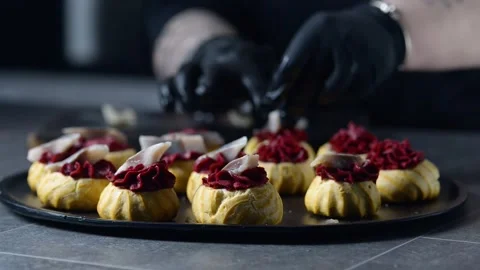 The chef is making profiteroles with herring and beet cream. Stock Footage 277491882