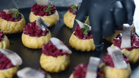 The chef is making profiteroles with herring and beet cream. Stock Footage 277491916