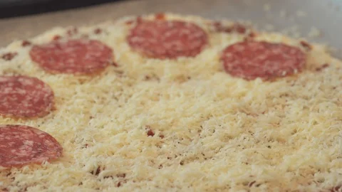 A chef making a salami pizza using hand with cheese Stock Footage 127984336