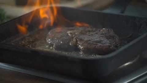 Chef making steak fillet mignon in flambe style on a grill pan. Delicious dish. Stock Footage 124756484