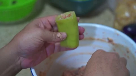A chef is making stuffed peppers, green peppers stuffed with meat Video stock 256644158