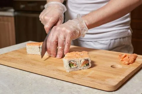 Chef making sushi. Preparing rolls with salmon Stock Photos