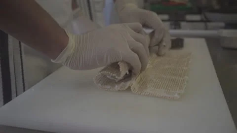 A chef is making sushi. The process of preparing an Asian sushi dish Vídeo Stock 144396757