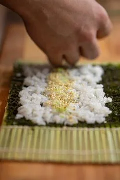 Chef making sushi roll with cucumber Stock Photos