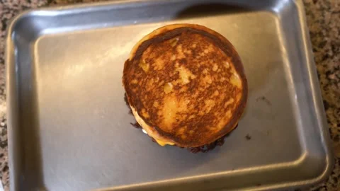 Chef making tasty burger. Cheeseburger with beef patty, cheese, tomato, onion. Stock Footage 261529904