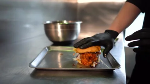 Chef making tasty burger. Cheeseburger with beef patty, cheese, tomato, onion. Stock Footage 261530013