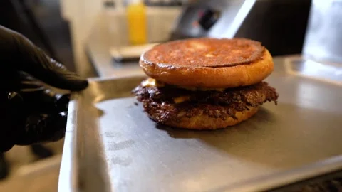 Chef making tasty burger. Cheeseburger with beef patty, cheese, tomato, onion. Stock Footage 261530067