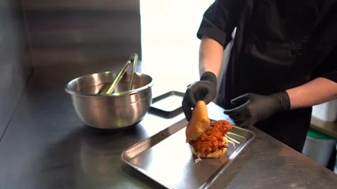 Chef making tasty burger. Cheeseburger with beef patty, cheese, tomato, onion. Stock Footage 261530301