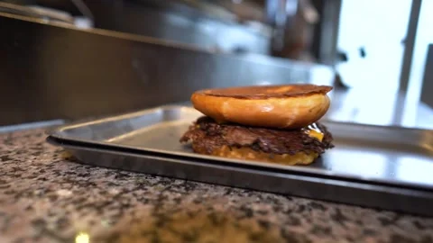 Chef making tasty burger. Cheeseburger with beef patty, cheese, tomato, onion. Stock Footage 261530403