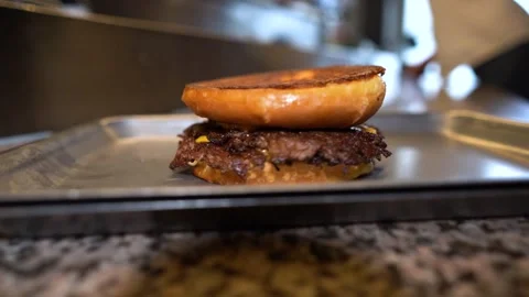 Chef making tasty burger. Cheeseburger with beef patty, cheese, tomato, onion. Stock Footage 262449300