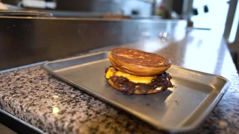 Chef making tasty burger. Cheeseburger with beef patty, cheese, tomato, onion. Stock Footage 262449541