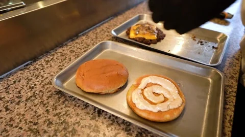Chef making tasty burger. Cheeseburger with beef patty, cheese, tomato, onion. Stock Footage 262451055