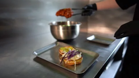 Chef making tasty burger. Cheeseburger with beef patty, cheese, tomato, onion. Stock Footage 262559290