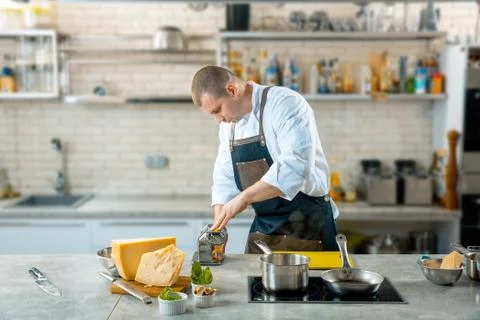 Chef is making thin dough with special machine, toned image Stock Photos