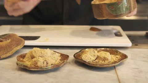 Chef is making warabi mochi by coating it with roasted soybean kinako flour. Stock Footage 232233523