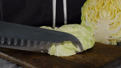 Chef male cutting off half a cabbage with a knife Stock-Footage 128519782